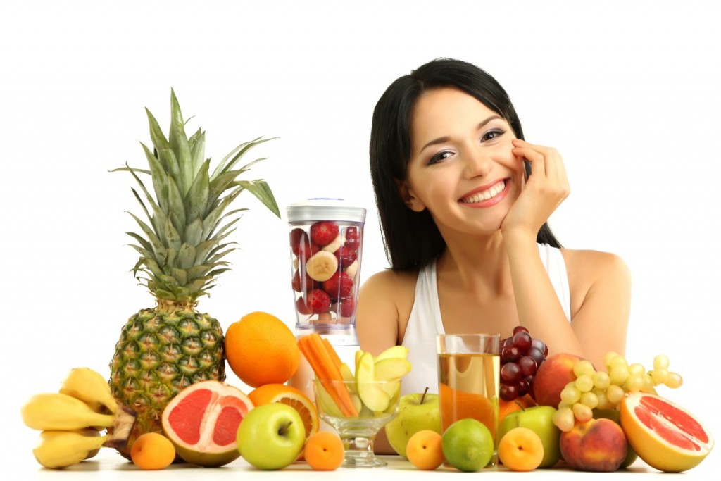 Girl with fresh fruits isolated on white